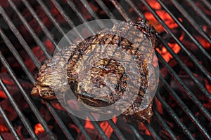 Grilled meat, steak. Photograph of food on a dark background