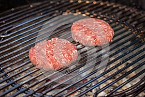 Grilled meat - two burgers on an outdoor grill