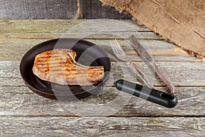 Grilled meat and vegetables on rustic wooden table. savory sauces and salt served with grilled steak on a rustic wooden