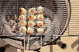 grilled meatballs on charcoal stove, camping in winter, food for warmth in winter