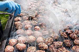 Grilled meatballs at picnic in rotisserie