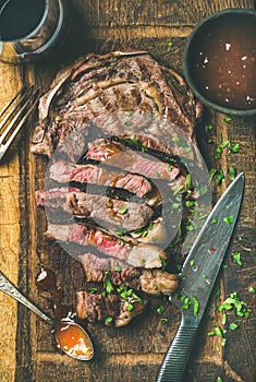 Grilled medium rare ribeye beef steak with red wine, flat-lay