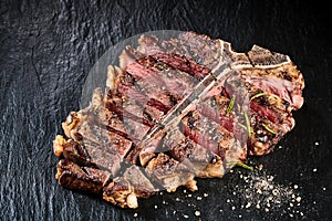 Grilled medium rare t-bone steak with seasoning