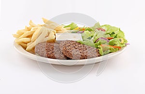 Grilled minced steak dish with salad, rice, french fries and sauce