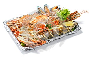 Grilled Mixed Seafoods platter Set contain Lobsters Fish Blue Clabs Big Shrimps Mussels Clams Calamari Squids with pieces of lemon