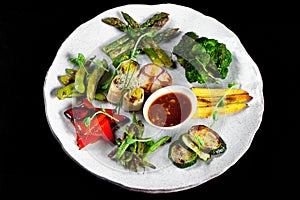 Grilled mixed vegetables on a white plate