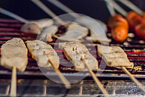 Grilled Moo Yor, or Vietnamese pork sausage steamed on electric stove for sale in the market