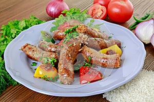 Grilled mumbar or sausage grill clodeup with onion, tomato and coriander served in dish isolated on table side view of arabic food