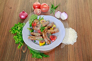 Grilled mumbar or sausage grill with onion, tomato and coriander served in dish isolated on table top view of arabic food
