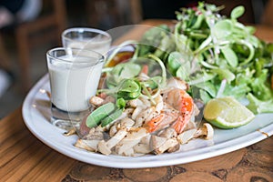 Grilled mushrooms, grilled shrimp salad on white plate