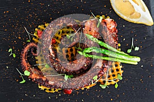 Grilled Octopus appetizer with small potatoes, close view