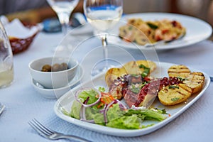 Grilled octopus with baked potatoes