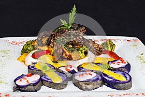 Grilled Octopus, gourmet dish from Peru. Served with purple potatoes (nativa) photo