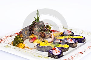 Grilled Octopus, gourmet dish from Peru. Served with purple potatoes (nativa) photo