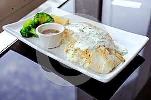 Grilled Pangasius with rice and white cream sauce