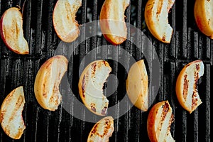 Grilled peach on black gas grill. Grilled dessert