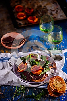 Grilled peaches, goat cheese, and bresaola salad