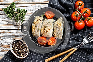 Grilled pollock or coalfish fillets in a pan. White background. Top view