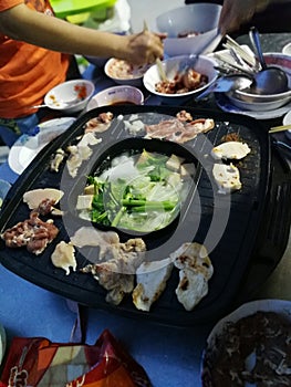 Grilled pork and chicken meat with vegetables soup