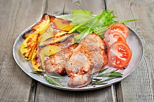 Grilled pork chop on rustic table