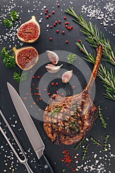 Grilled pork chop tomahawk on slate board