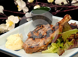 Grilled pork chops with mashed potatoes and salad