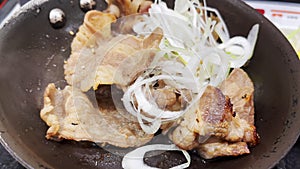 Grilled pork marinated in Japanese sauce on a pan with onions