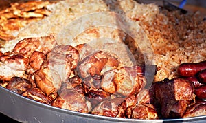 Grilled pork meat and cabbage - traditional Slovak street food - prepared on street, closeup detail
