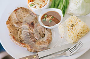 Grilled pork, papaya salad, vegetables and rice with spicy sauce