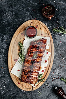 Grilled pork ribs with BBQ sauce. vertical image. top view. place for text