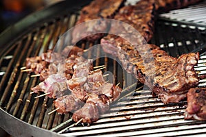 Grilled pork ribs on the grill. Street food background. Marinated pork spare ribs. Street market. Fresh grilled meat