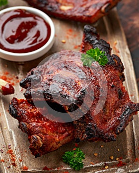 Grilled pork ribs with herbs on wooden board
