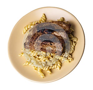 Grilled pork ribs with pasta. grilled pork ribs on a plate isolated on white background top view