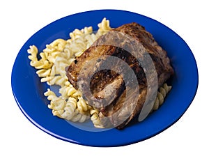 Grilled pork ribs with pasta. grilled pork ribs on a  plate isolated on white background top view