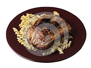 Grilled pork ribs with pasta. grilled pork ribs on a plate isolated on white background top view