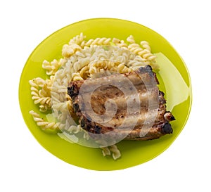 Grilled pork ribs with pasta. grilled pork ribs on a plate isolated on white background top view