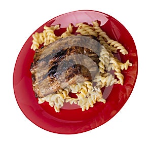 Grilled pork ribs with pasta. grilled pork ribs on a plate isolated on white background top view