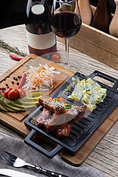 Grilled pork ribs served with marinated vegetables