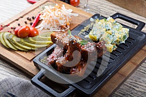 Grilled pork ribs served with marinated vegetables