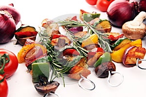 Grilled pork shish or kebab on skewers with vegetables . Food background shashlik