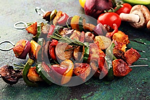 Grilled pork shish or kebab on skewers with vegetables . Food background shashlik