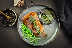 Grilled pork steak with edamame beans and Chimichurri sauce photo