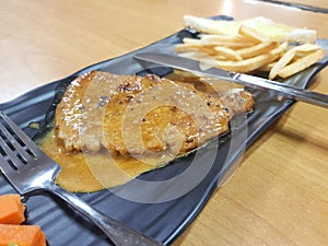 Grill pork steak with frech fries on dish background