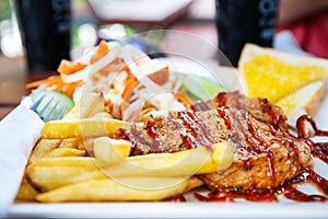 Grilled pork steak with salad on a plate