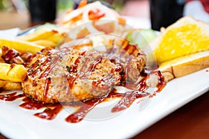 Grilled pork steak with salad on a plate