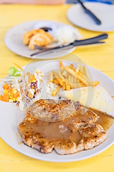 Grilled Pork Steak Wit French Fries On Dish