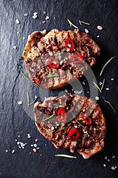 Grilled pork steaks with chili peppers and spices