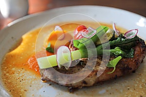 Grilled Porkchop and vegetables on top on wood background