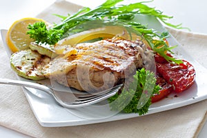 Grilled portion of flounder with vegetables