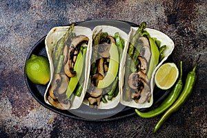 Grilled portobello, asparagus, bell peppers, green beans fajitas. Poblano mushroom tacos with jalapeno, cilantro, avocado crema photo